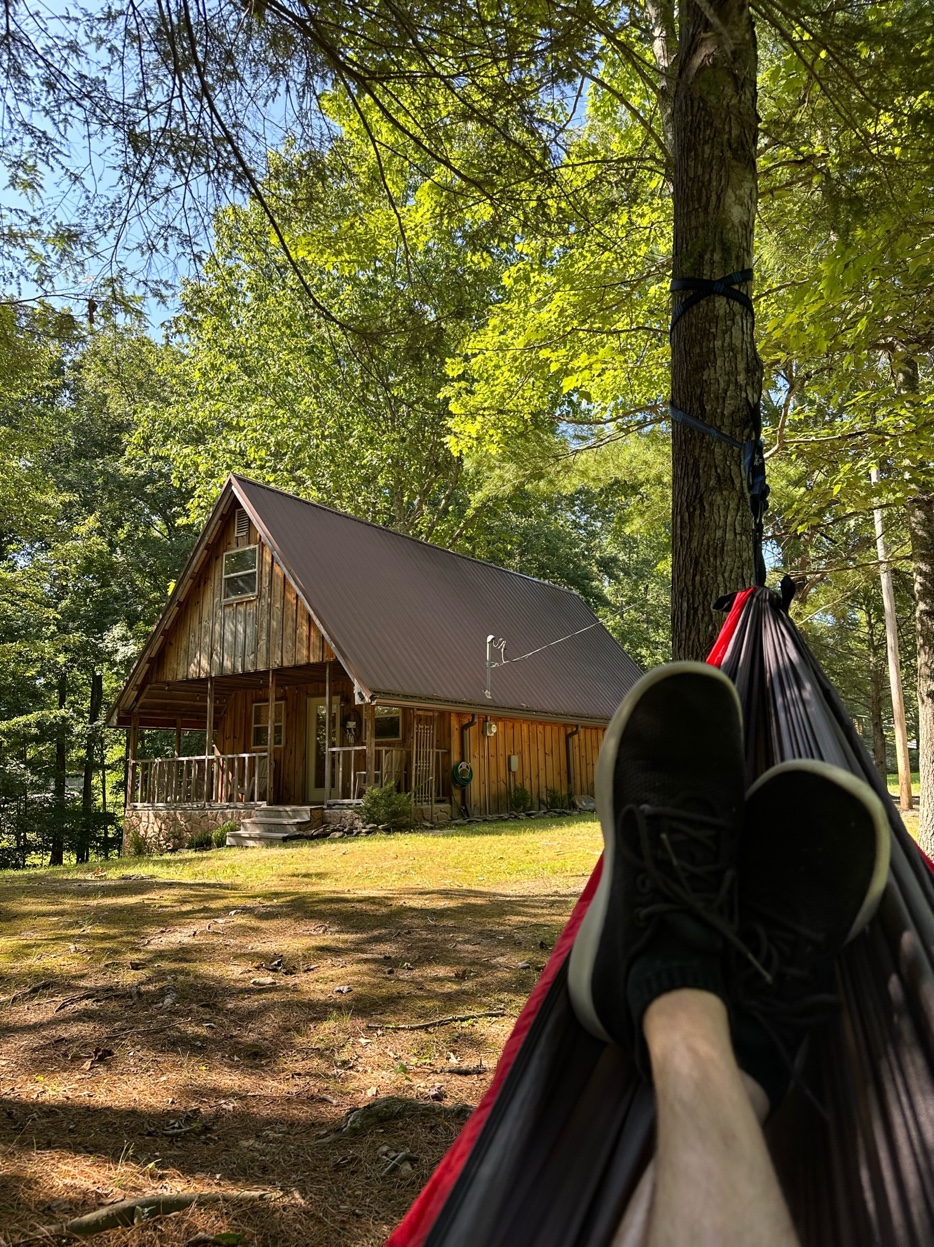 Relaxing in hammock with cabin view